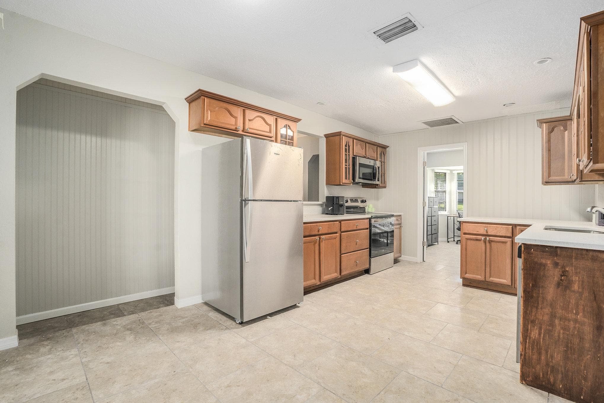 Welcome to your new culinary haven! This modern kitchen boasts ample cabinetry, sleek stainless steel appliances, and a spacious layout, perfect for preparing delightful meals and hosting gatherings with your housemates. The soft colors and clean lines create an inviting atmosphere for all your culinary adventures.