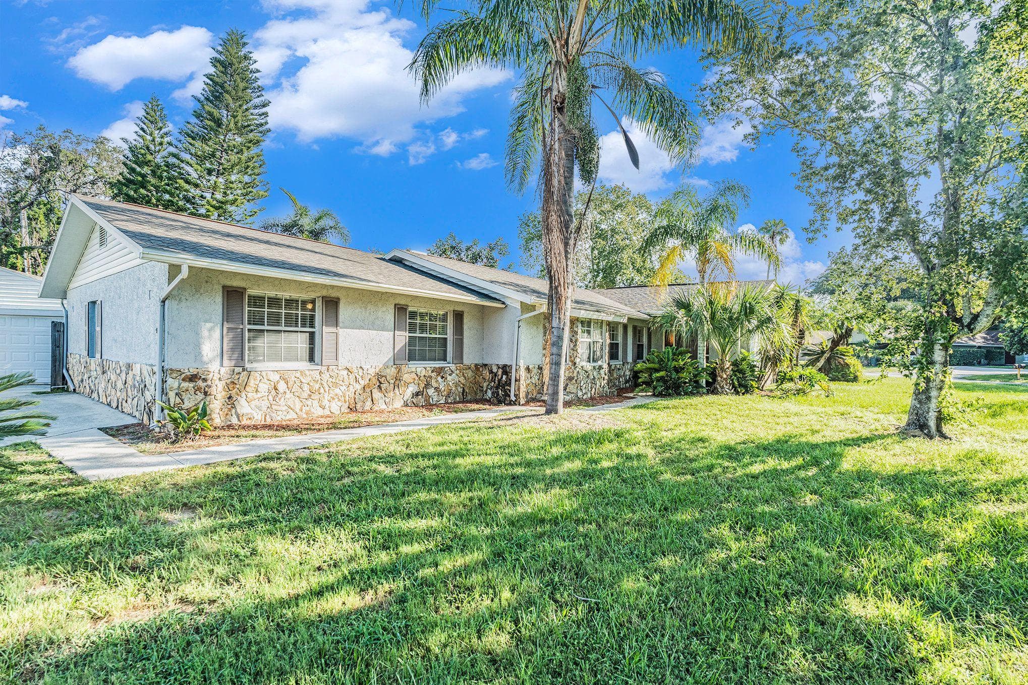 Welcome to your future home! This stunning exterior showcases beautiful landscaping and a welcoming façade, perfect for socializing with neighbors or enjoying peaceful moments in the sun. The spacious front yard invites outdoor activities, making it an ideal setting for a vibrant community feel.