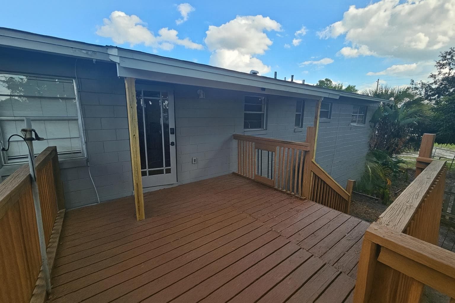 Welcome to your future home! This inviting exterior view showcases a charming entrance with a spacious wooden deck, perfect for relaxing or socializing. The well-maintained facade hints at a comfortable living space waiting for you inside!