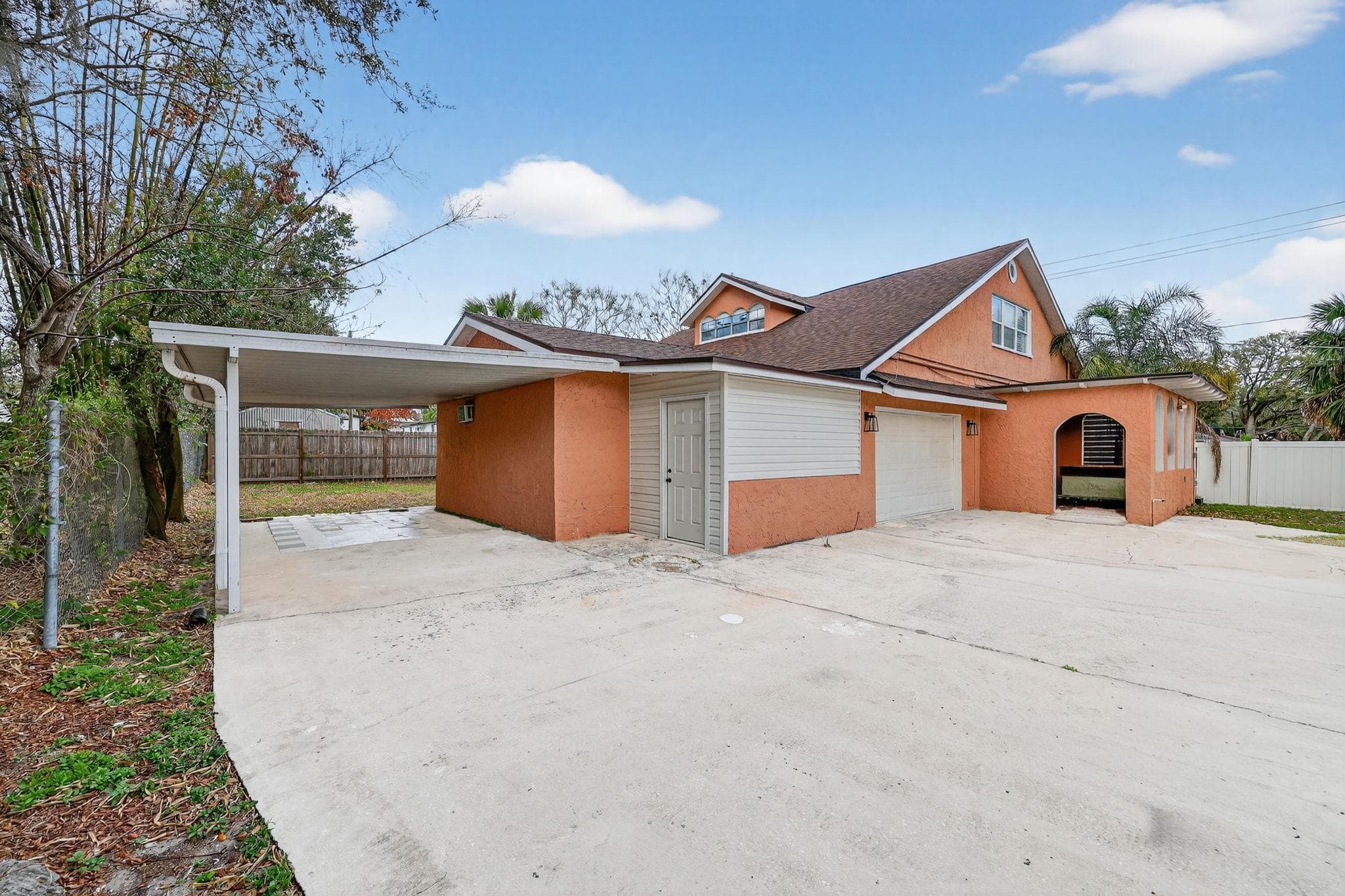 Welcome to this charming exterior space! With its warm orange hue and spacious driveway, this property exudes a welcoming charm. Imagine coming home to this appealing exterior that blends colorful aesthetics with practical parking spaces—perfect for your lifestyle!