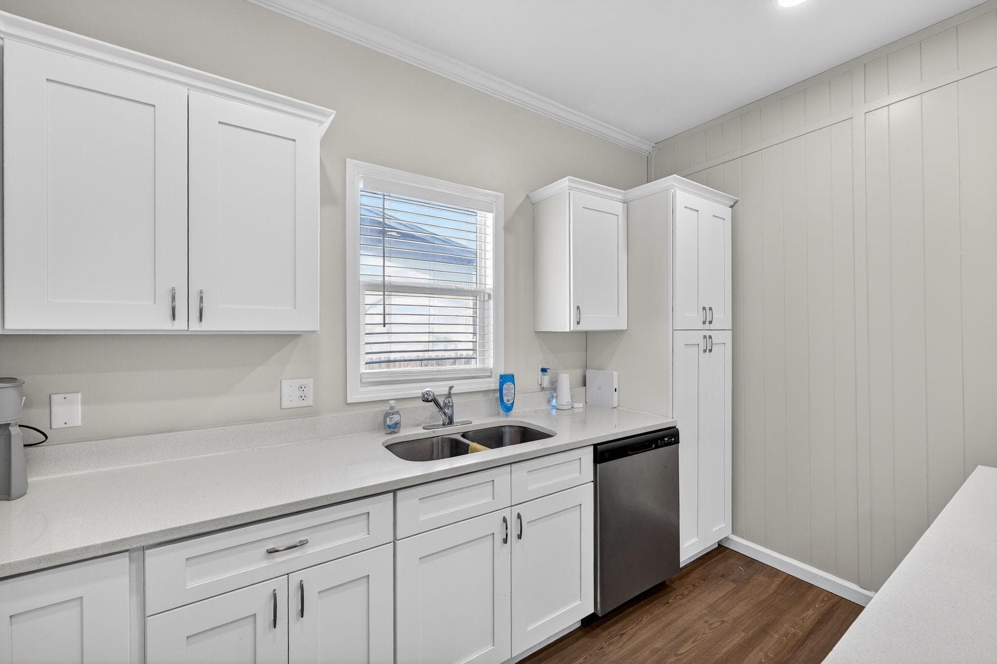 Welcome to your future kitchen! This bright and modern space features pristine white cabinetry, sleek countertops, and convenient stainless steel appliances. Perfect for whipping up meals and creating connections with fellow roommates!