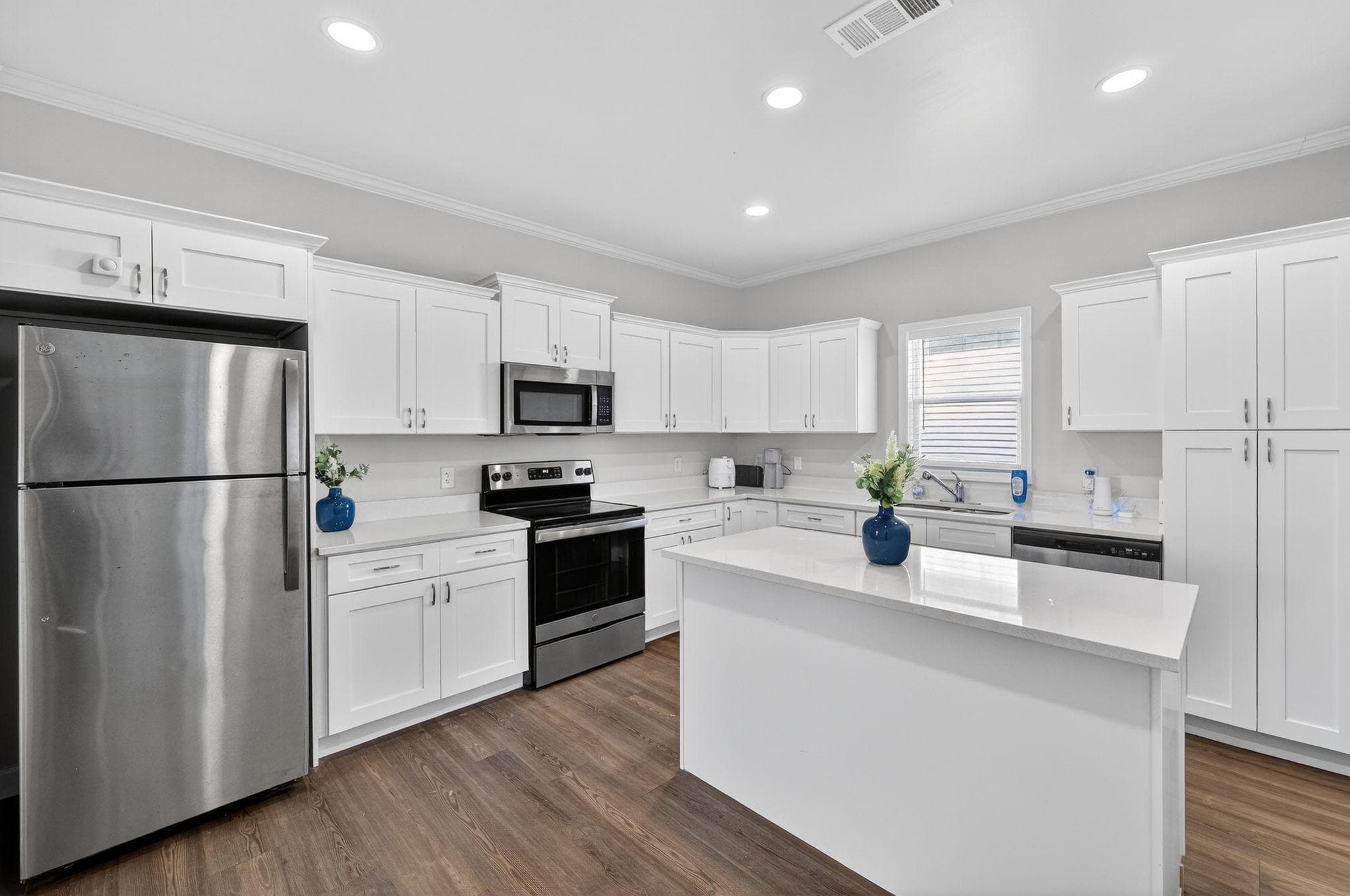 Step into this modern kitchen, where sleek stainless steel appliances meet a clean, bright aesthetic. With ample counter space and fresh white cabinetry, this kitchen is perfect for whipping up meals and entertaining friends in your future coliving home.