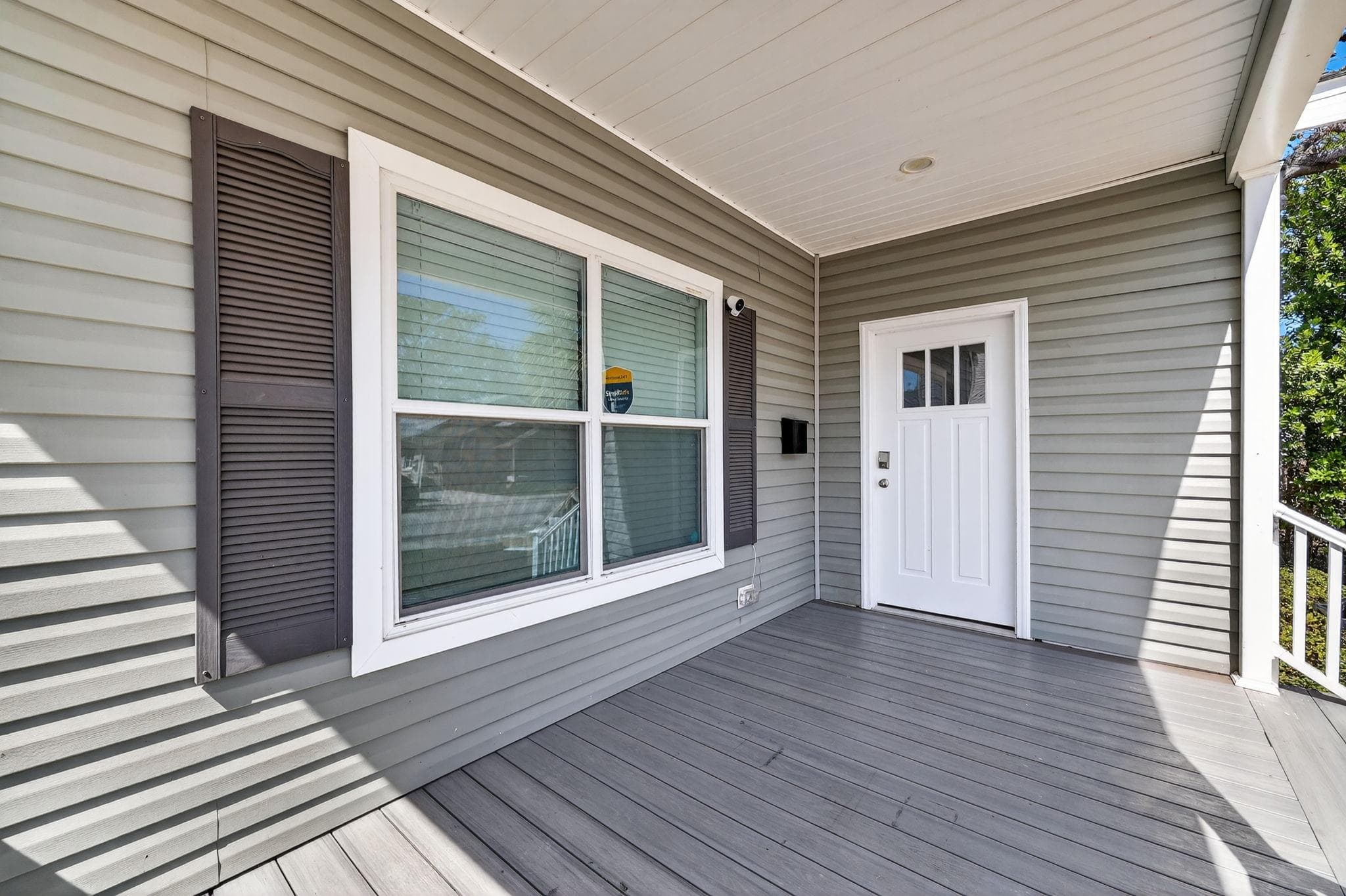 Step into this charming exterior showcasing a lovely entryway with contemporary paneling and abundant natural light filtering through the large windows. The inviting porch sets the perfect tone for a warm welcome, making it ideal for potential renters looking for a homely vibe.