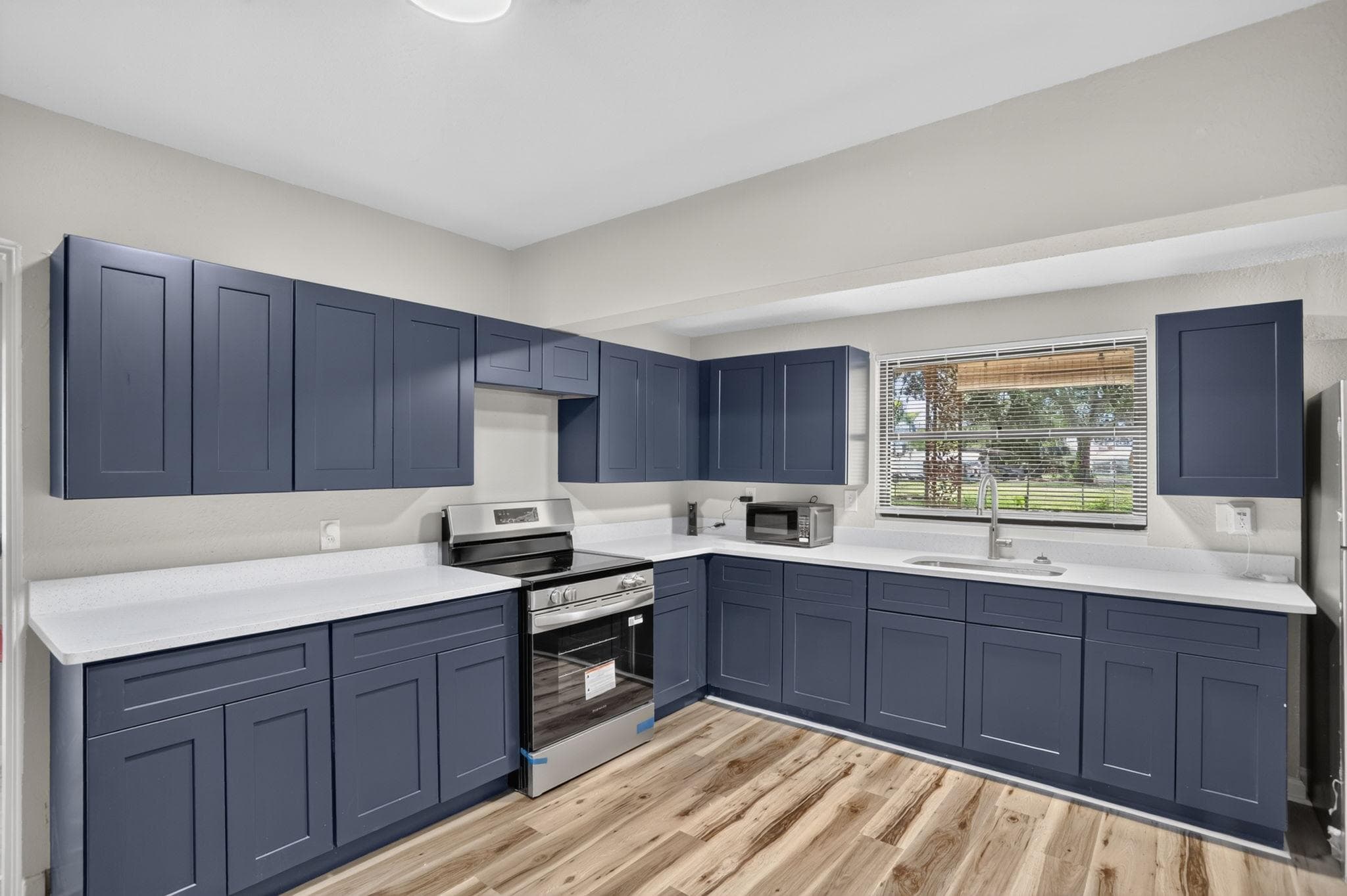 Updated U-shaped kitchen with ample cabinetry, generous counters, and a window over the sink for everyday meal prep.