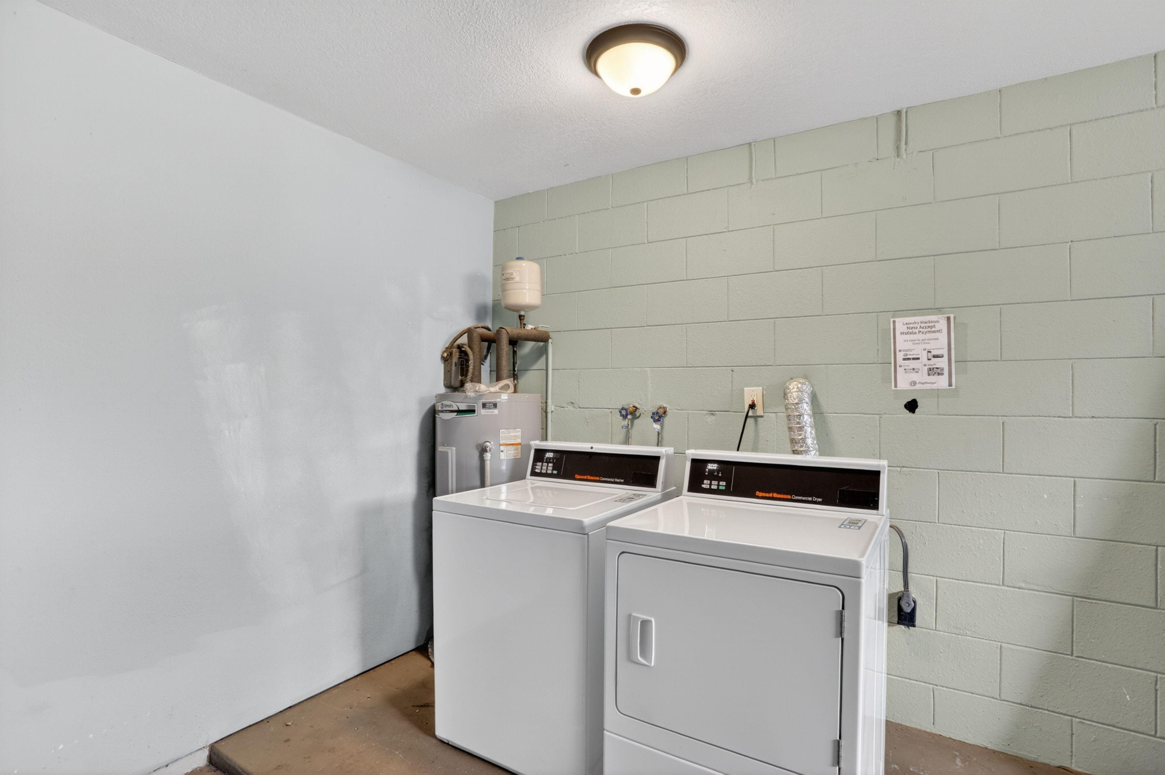 On-site laundry area with a full-size washer and dryer setup and utility connections for everyday convenience.