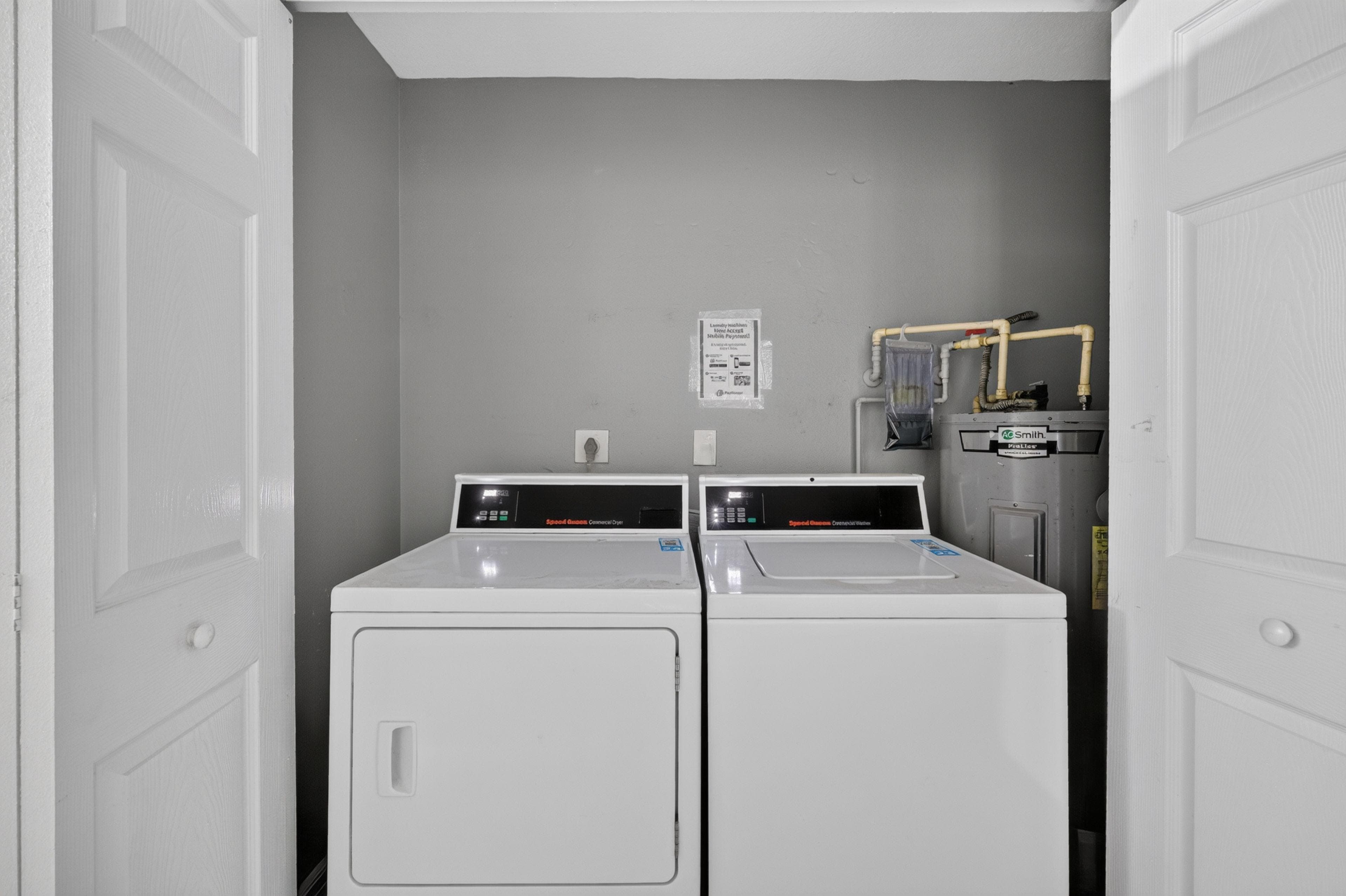 Dedicated laundry closet with full-size washer and dryer for convenient in-home laundry.